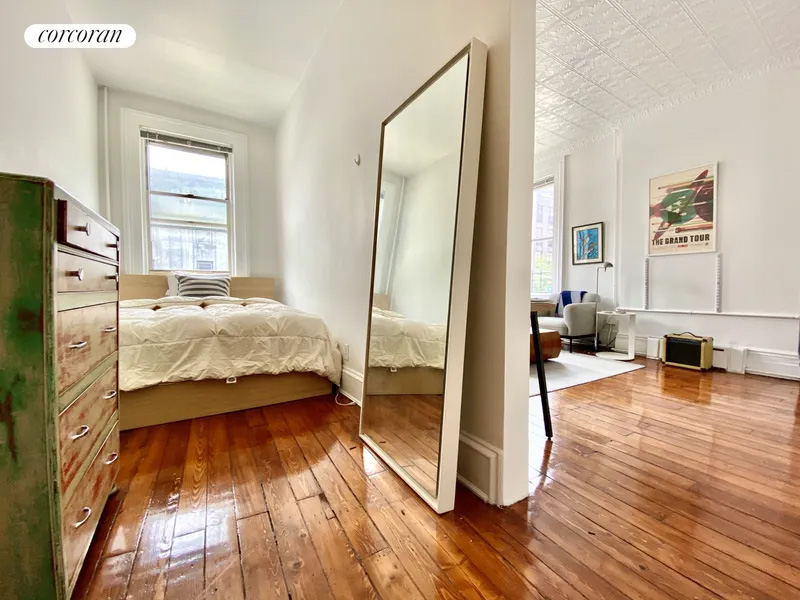 bedroom with room for a queen bed and view into living