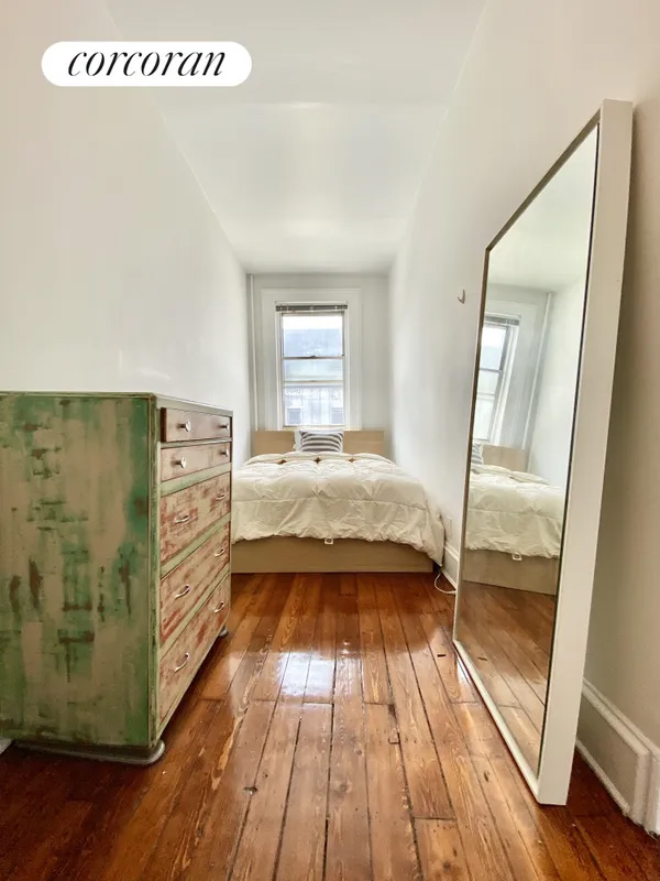 bedroom with wood floor, room for a queen bed