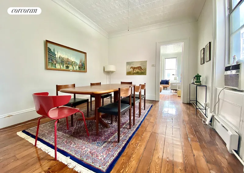dining room with wood floor, tin ceiling