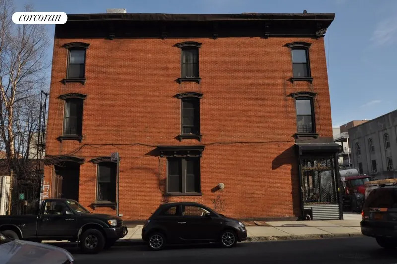 side facade of brick building with commercial ground floor