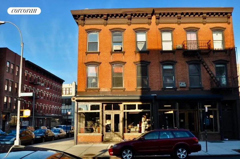 front facade of brick building with commercial ground floor
