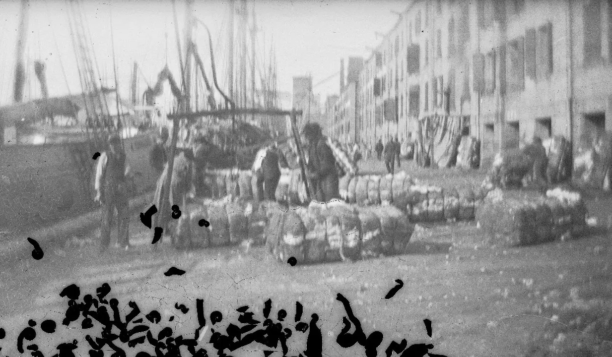 black and white photo of workers on docks