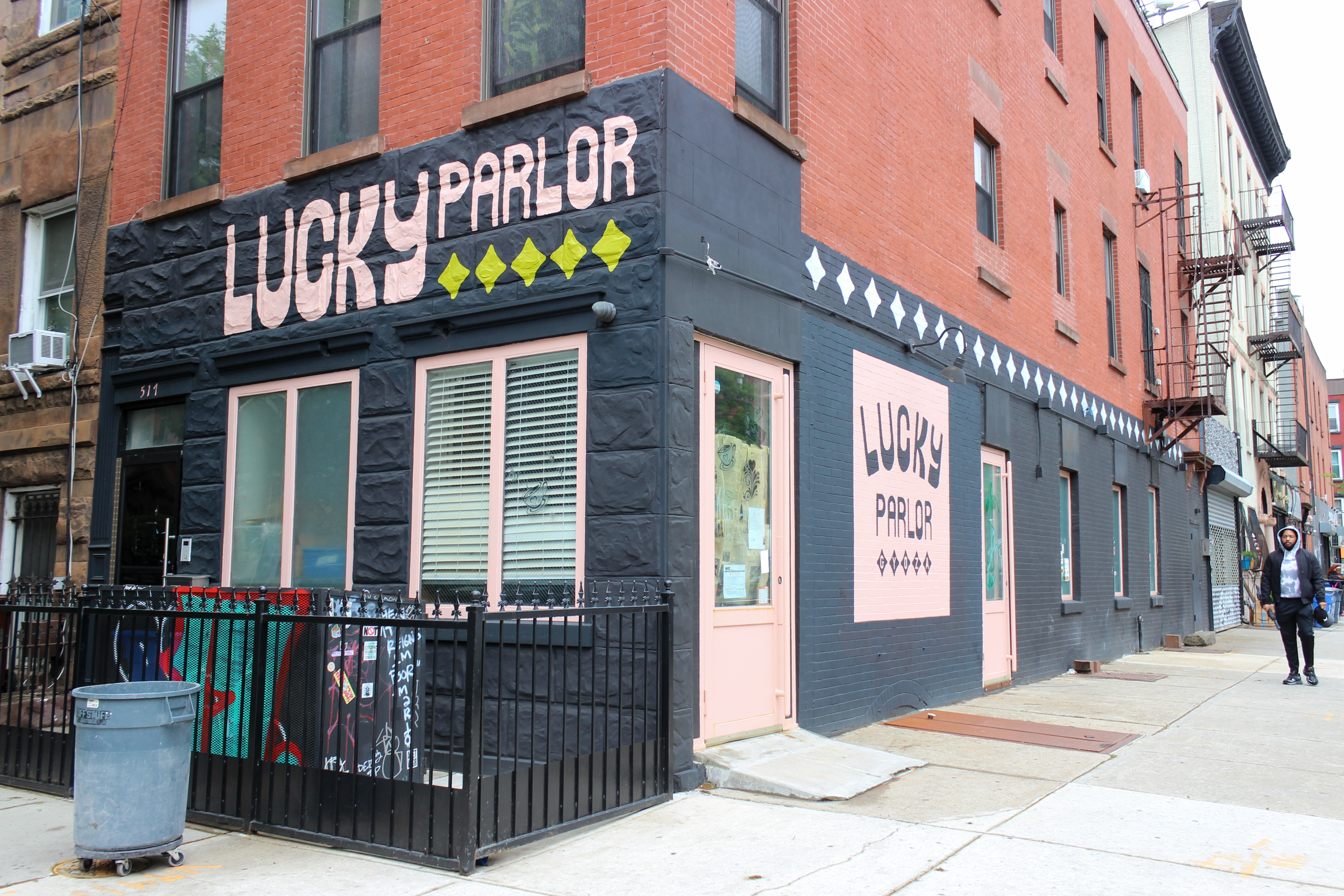 lucky parlor painted in pink on black storefront
