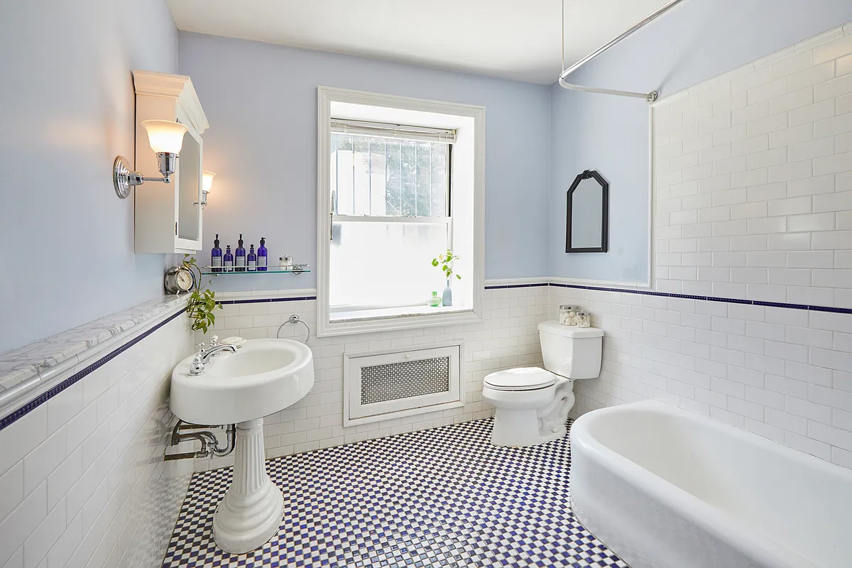 bathroom with checked floor, white fixtures