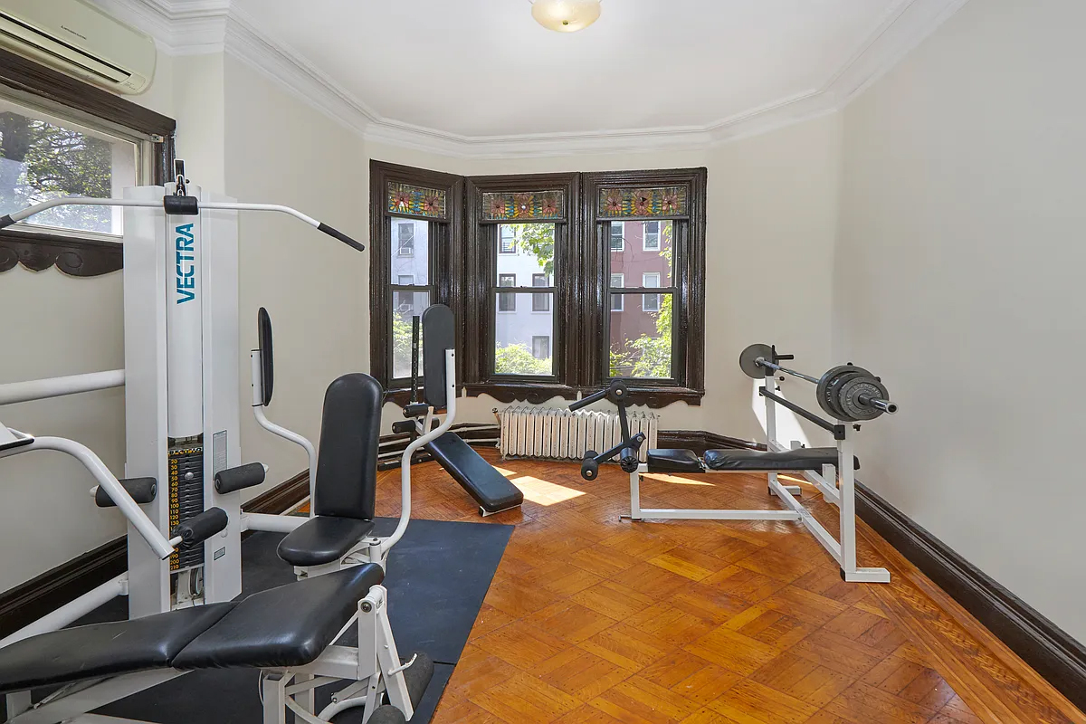 bedroom with wood floor set up as a gym