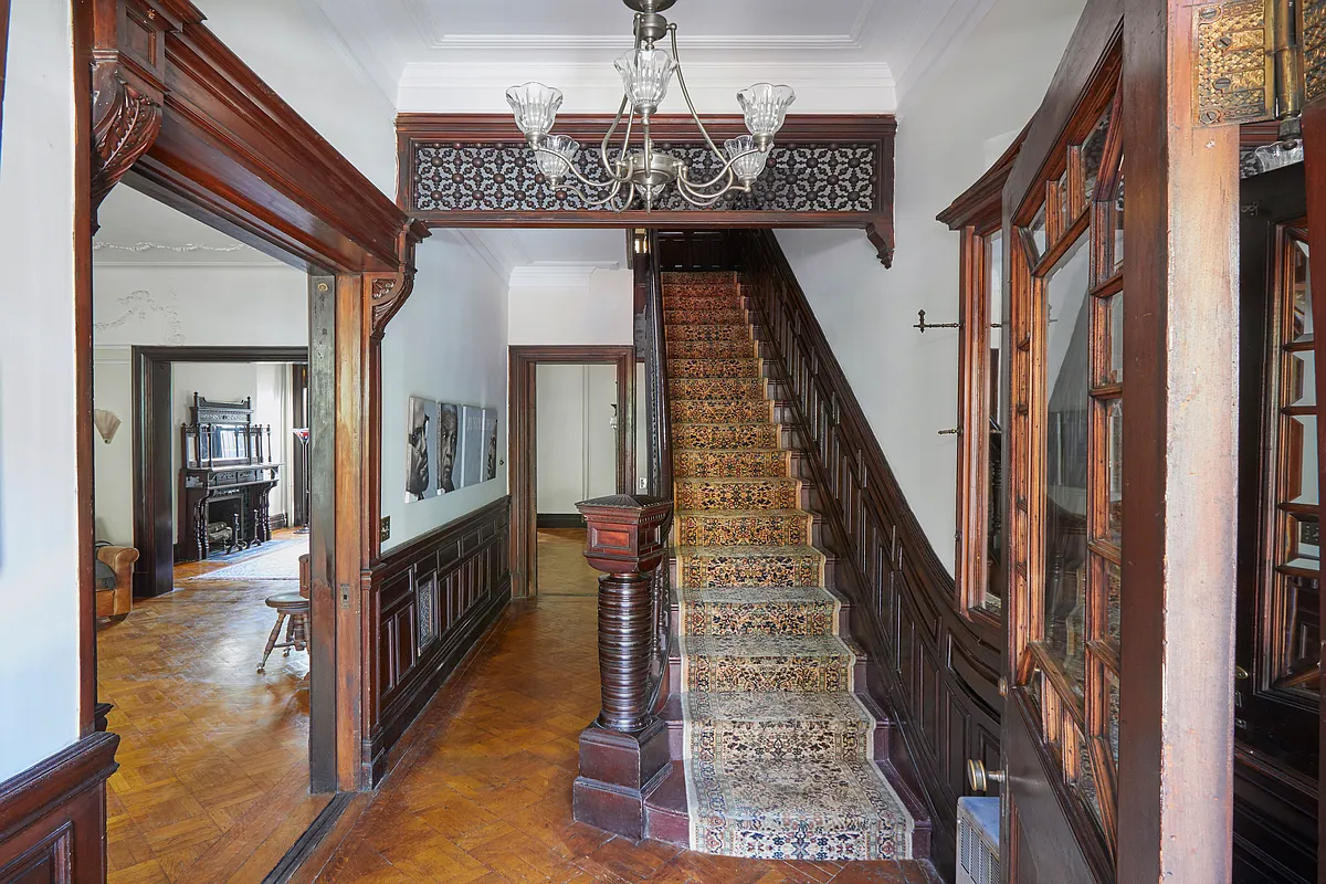 entry hall with fretwork, mirror, stair