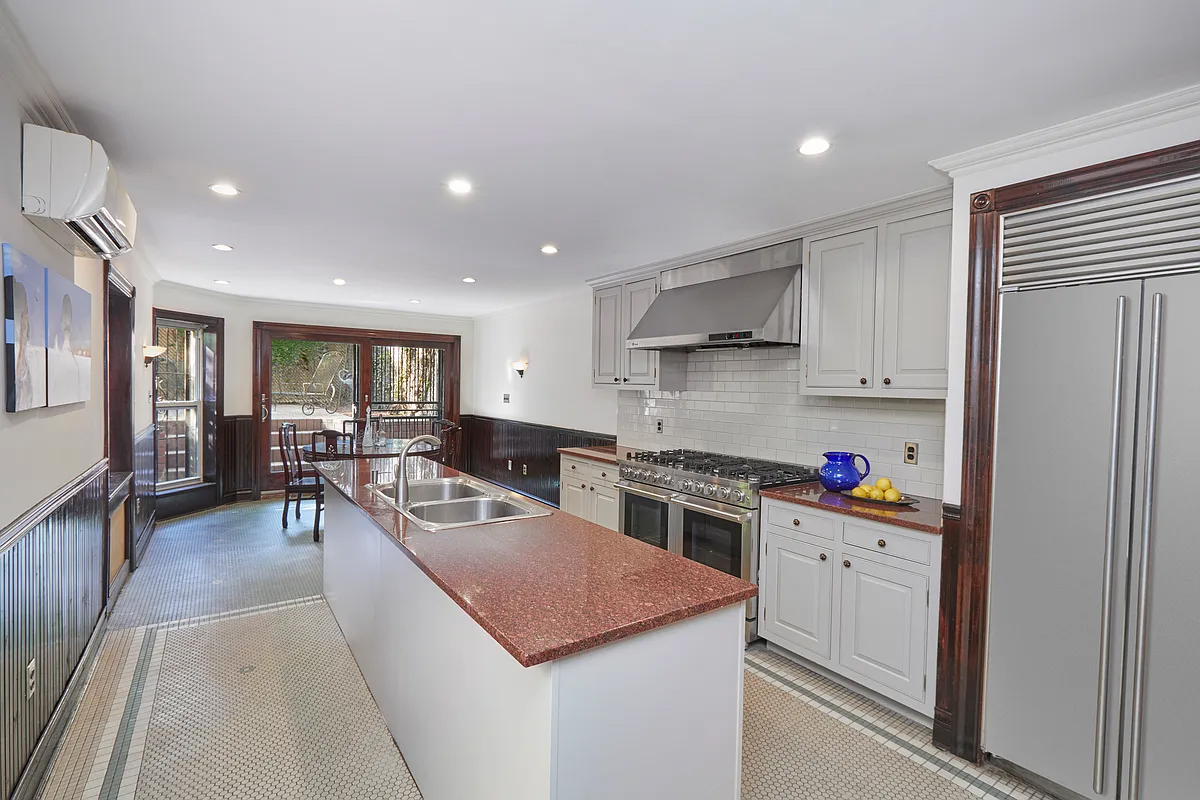 kitchen with white cabinets, doors to rear yard