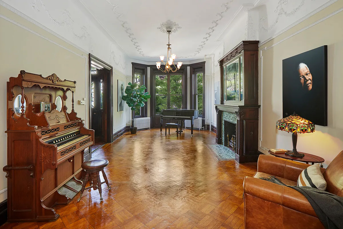 parlor with mantel, parquet floor, plasterwork