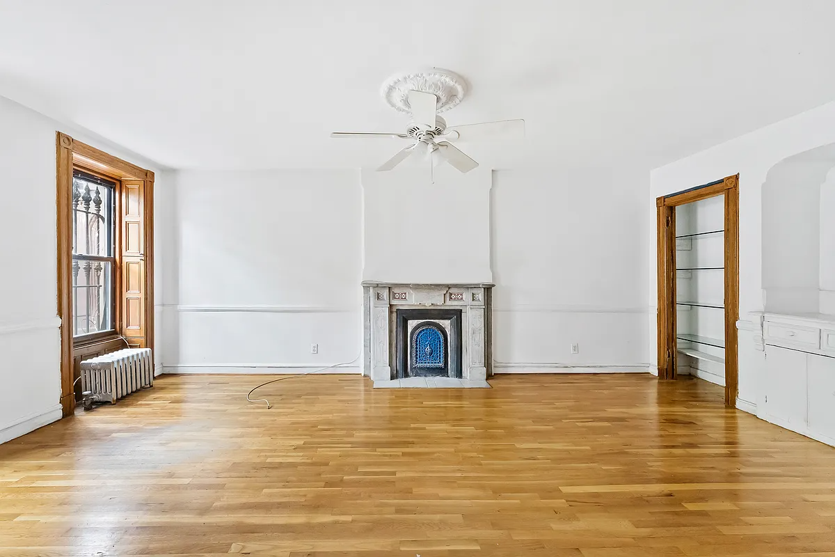 garden level bedroom in former dining room with built-in, marble mantel