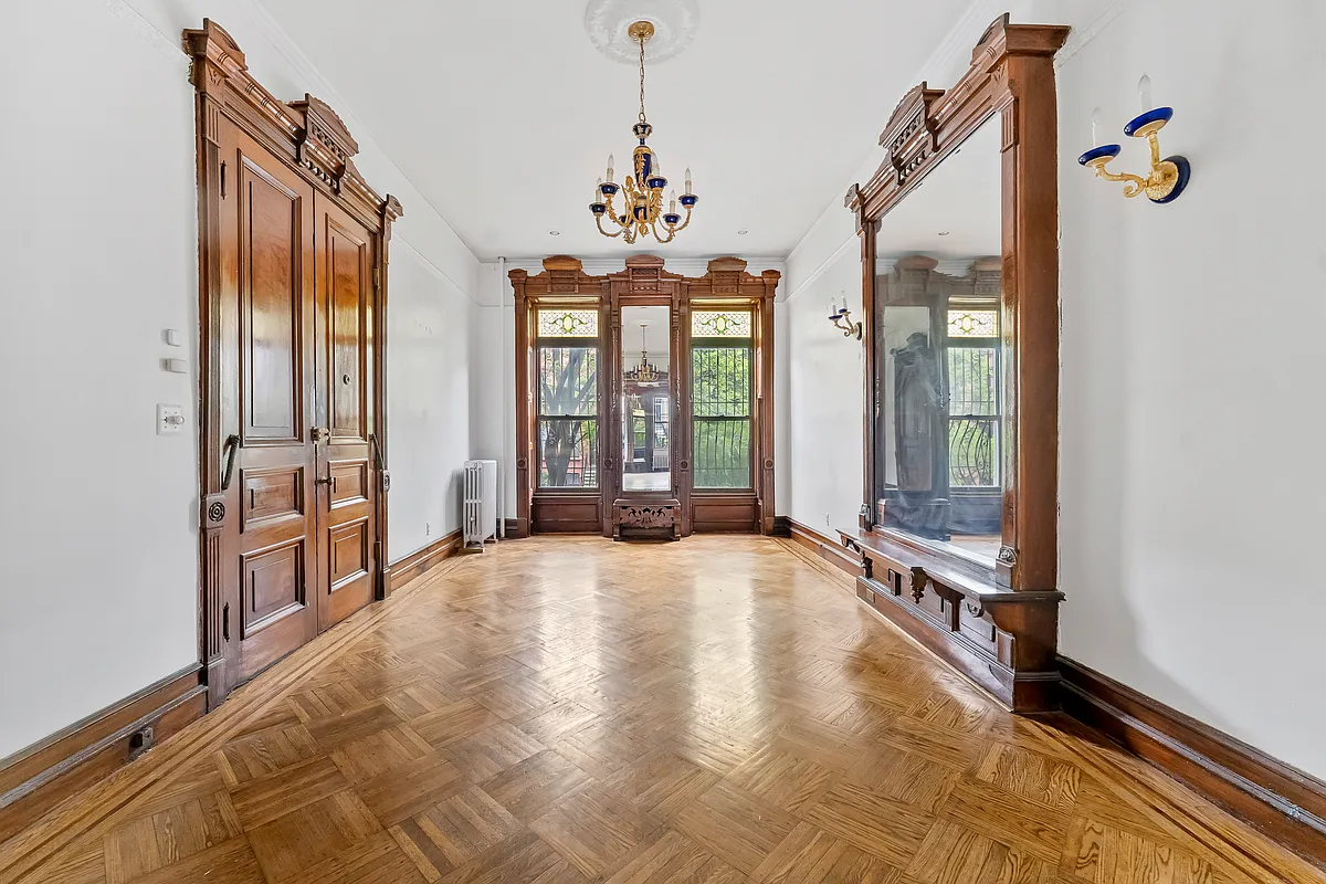 rear parlor with pier mirror, wood floor, stained glass