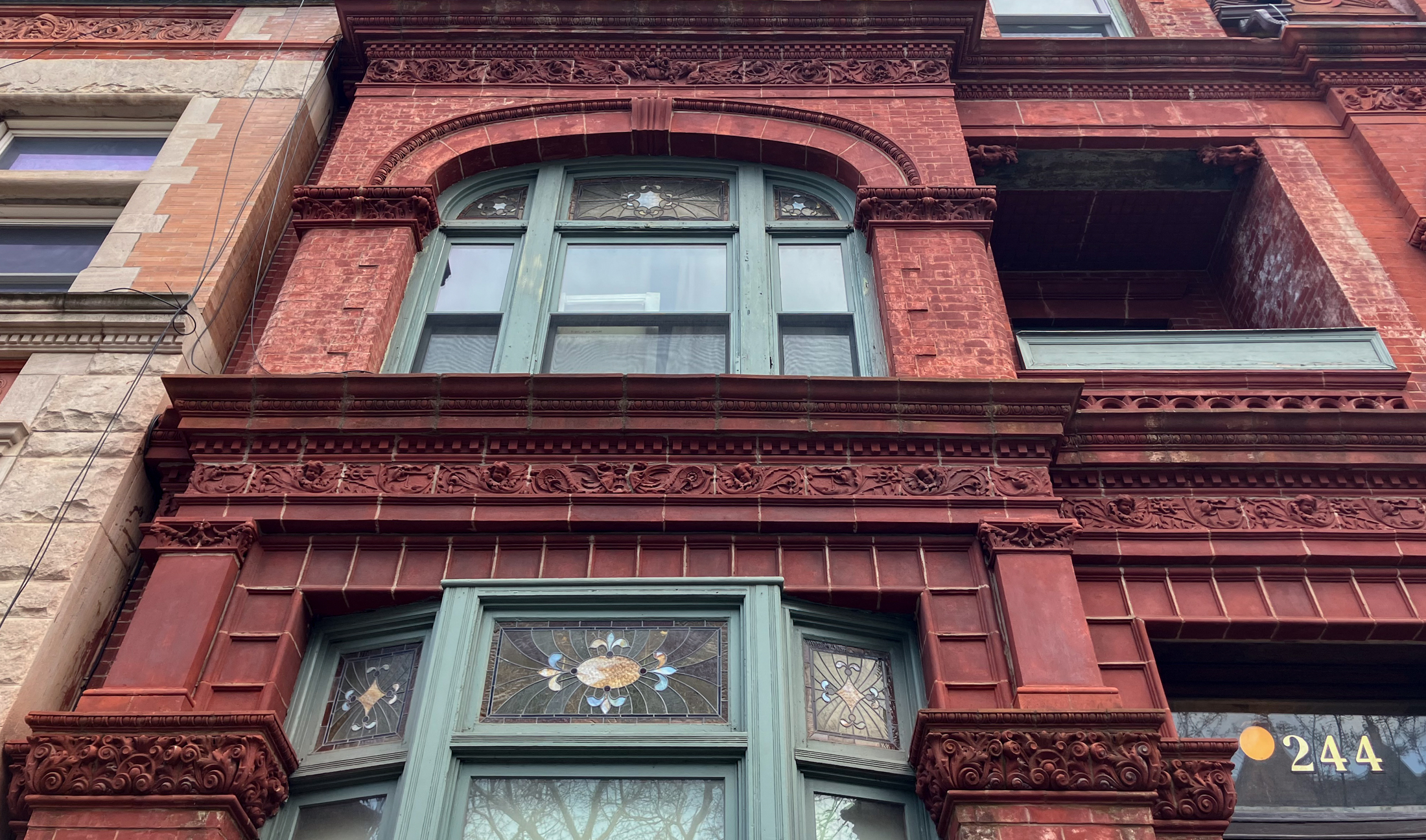 brooklyn - stained glass and ornament on a bed stuy house