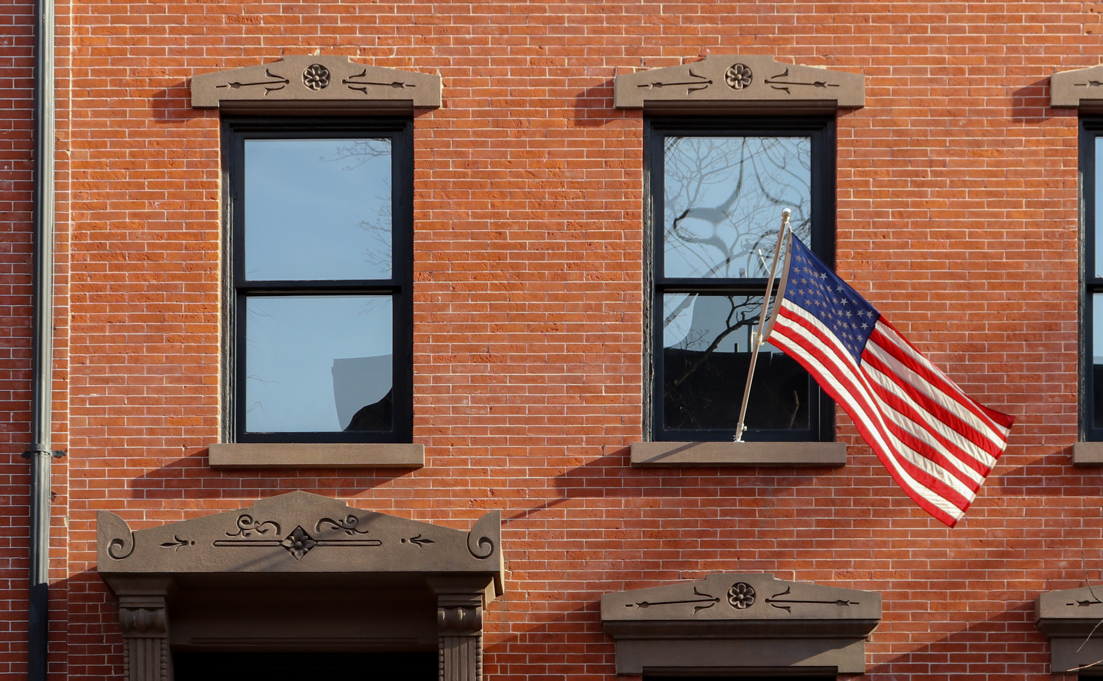 brooklyn - a flag waving on a brooklyn heights row house