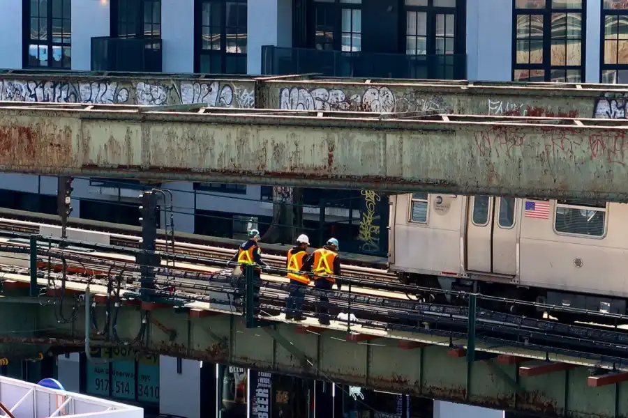 Construction workers perform maintenance on the elevated M line in Bushwick.