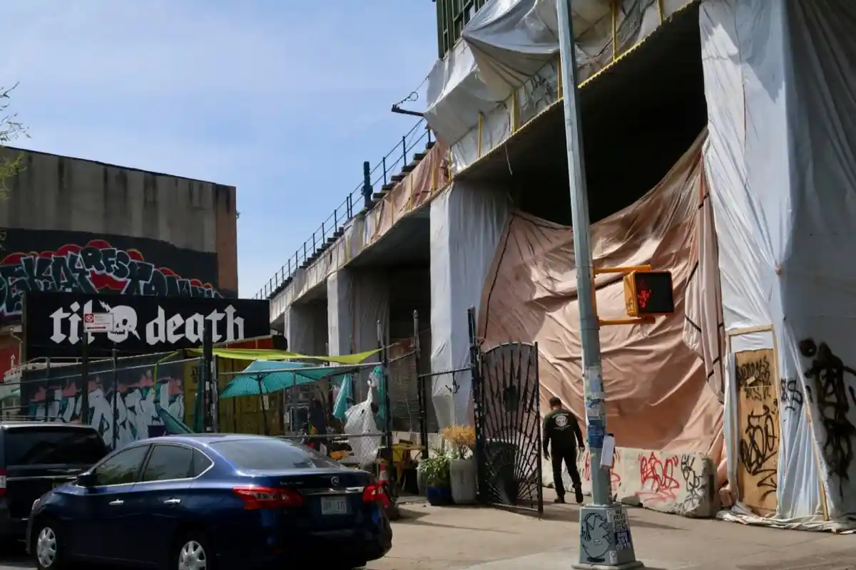 The construction tarp protecting Til Death Café from construction along the M train line in Bushwick has led to a significant drop in foot traffic and revenue for the popular outdoor coffee shop.