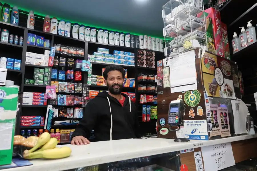 Mike Kassin, a cashier at Sam’s Deli, says construction noise and blocked storefront access have driven away customers.