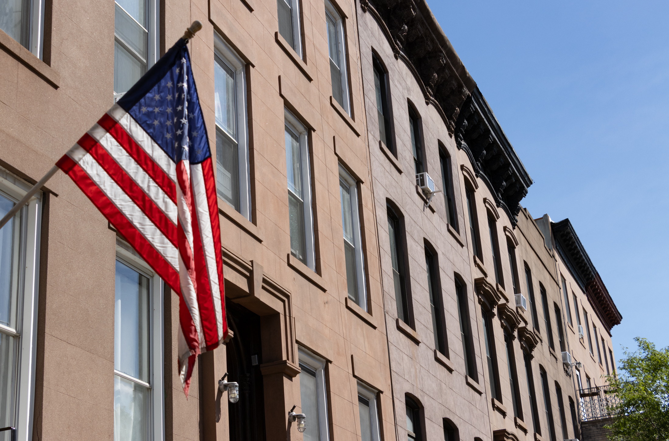 brooklyn - flag waving in front of cobble hill brownstones
