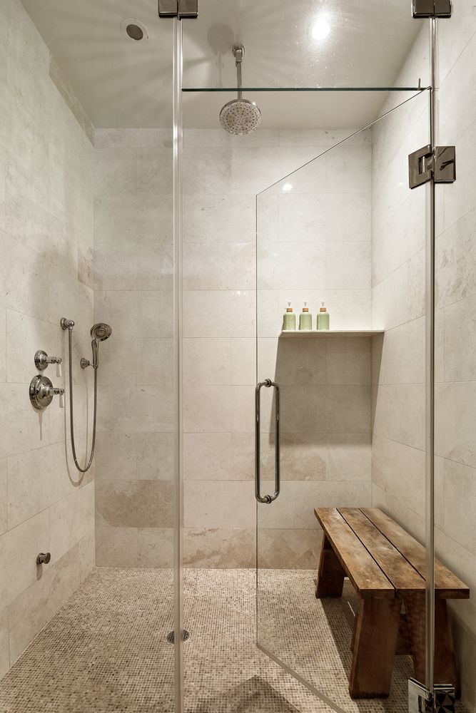 large walk-in shower with bench, glass doors