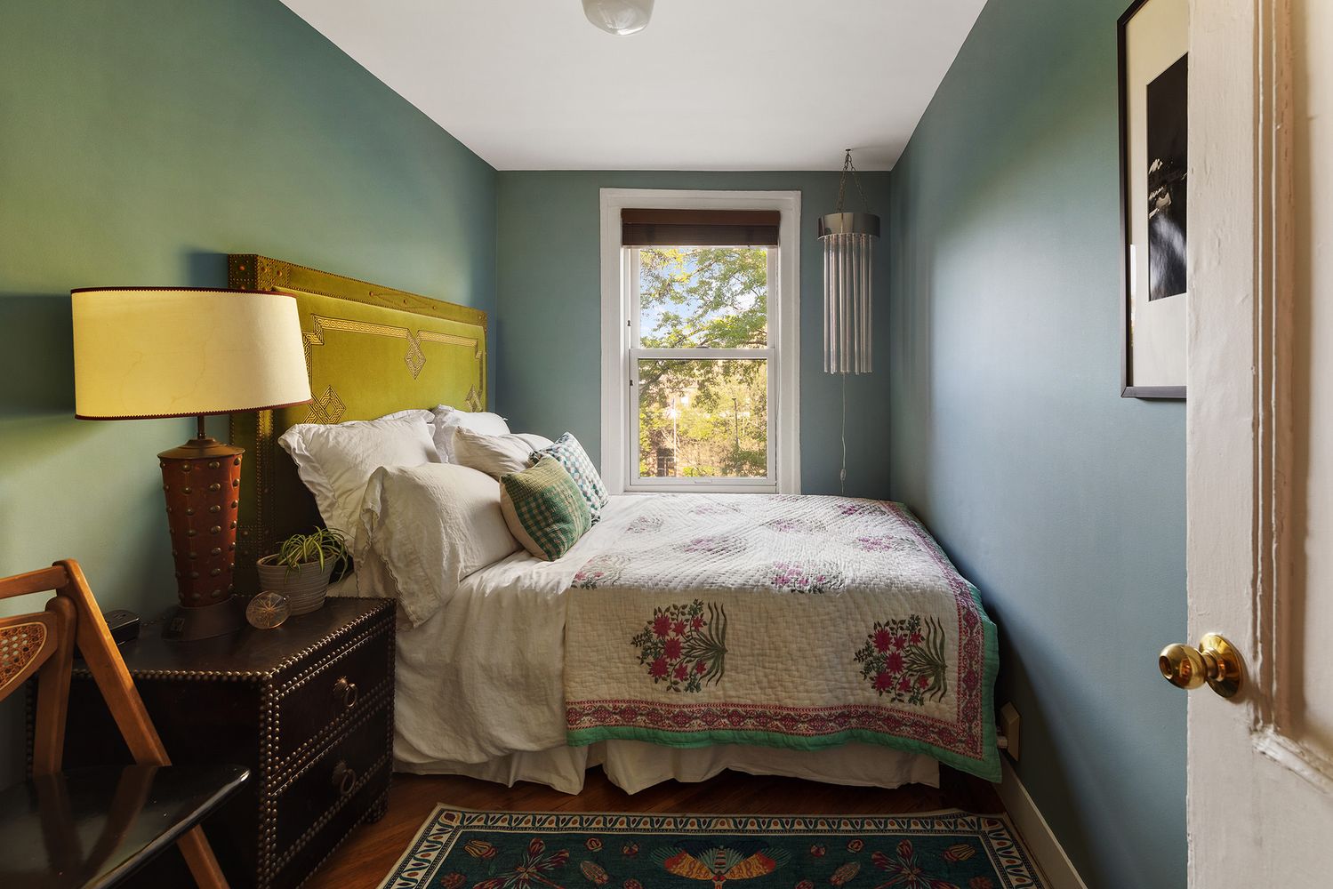 narrow bedroom with blue walls