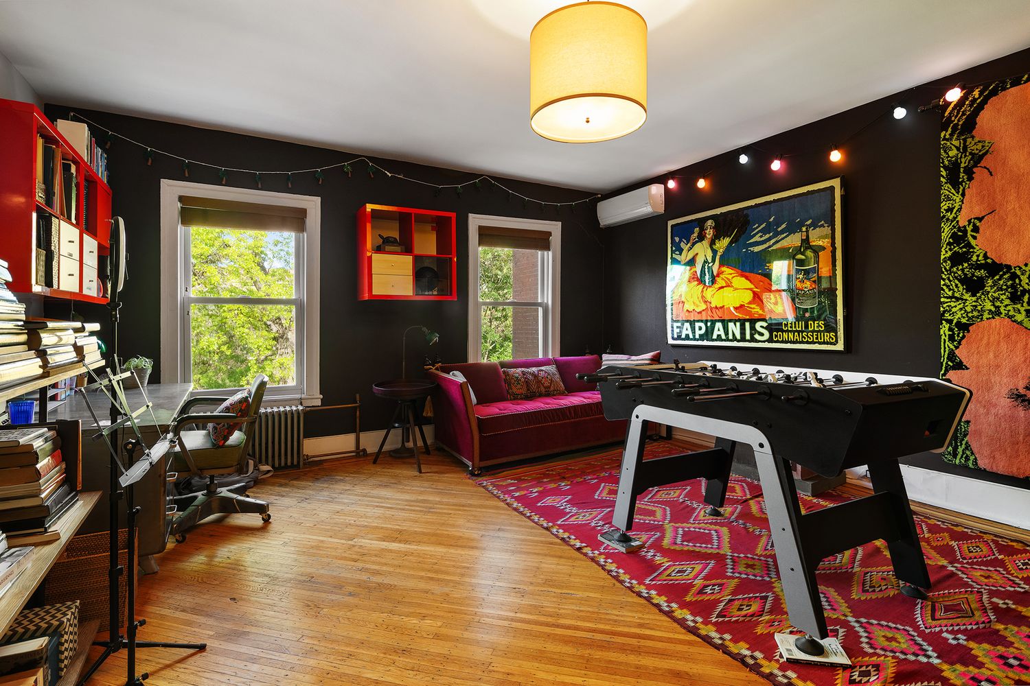 office with dark walls, wood floor