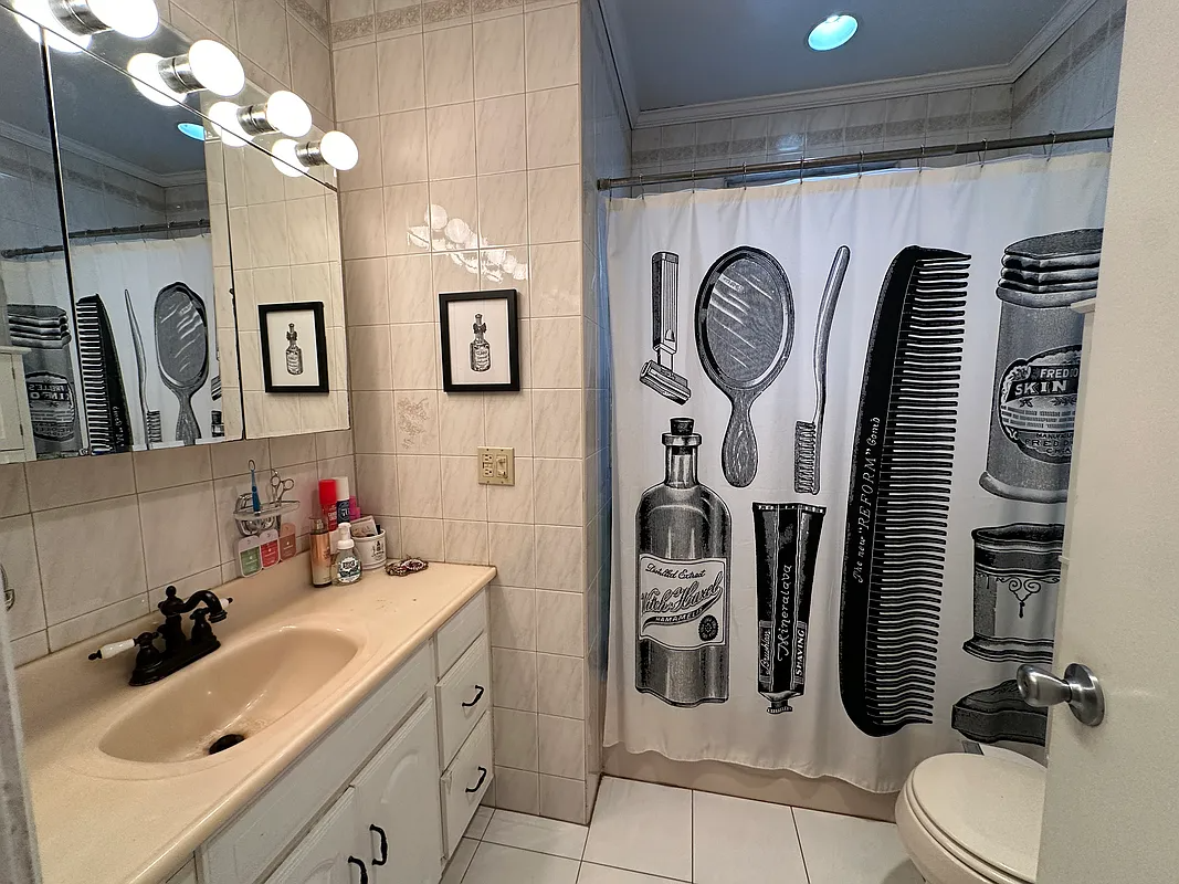 bathroom with beige wall tile, beige fixtures