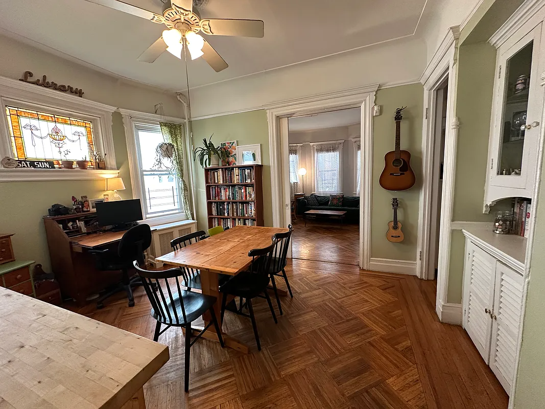 dining room with wood floor, built-in, stained glass
