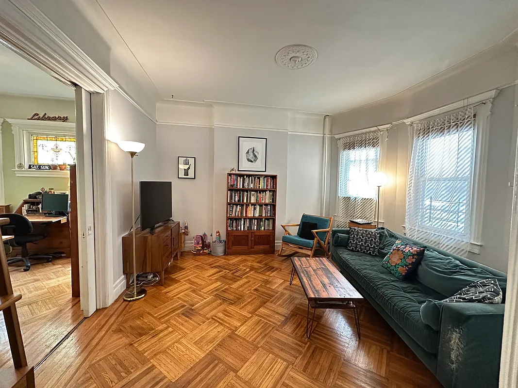 living room with wood floor, picture rails, pocket doors
