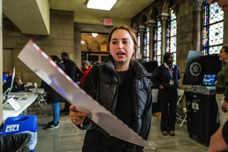 A voter with their covered ballot at Riverside Church in Harlem on Nov. 5, 2024.