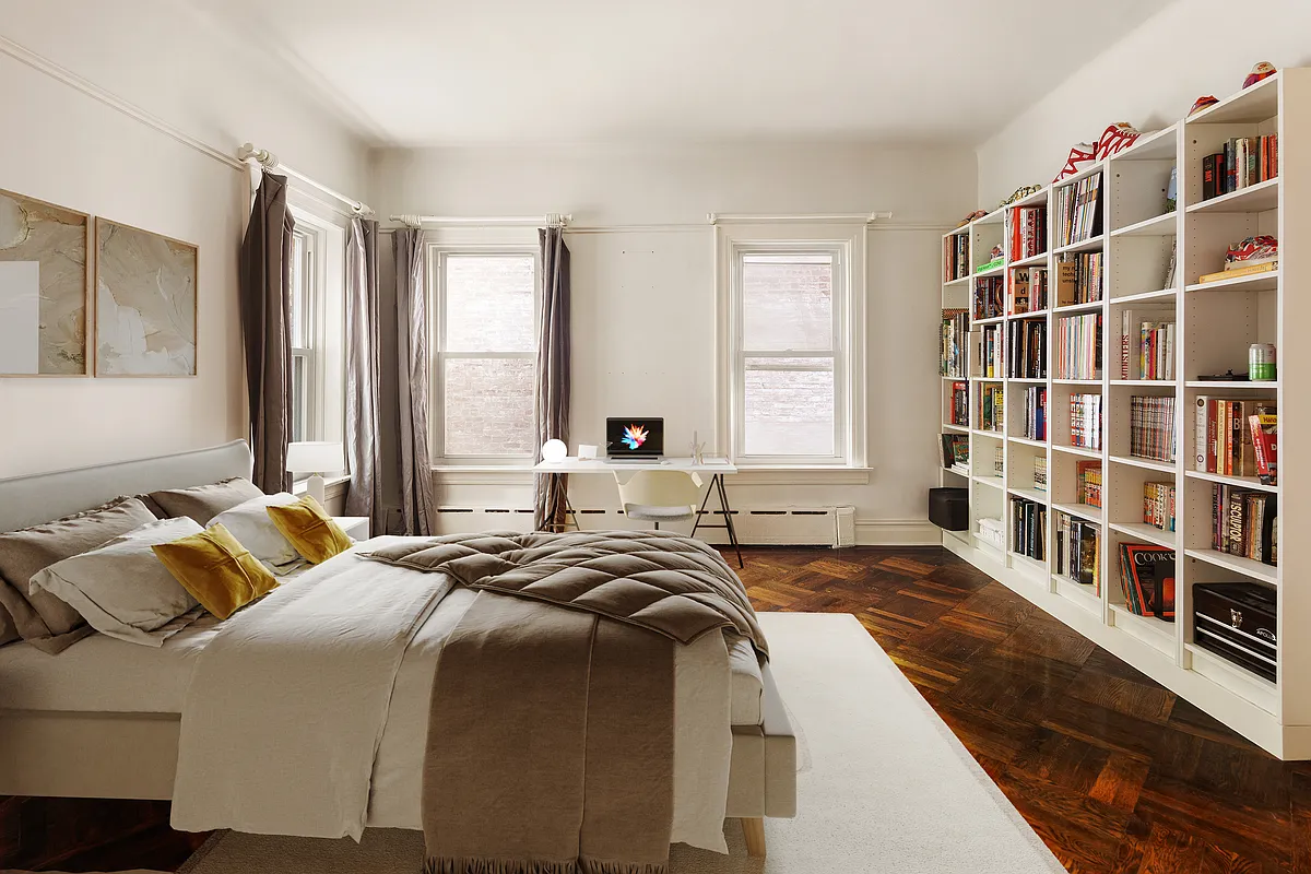 bedroom with wall of bookshelves