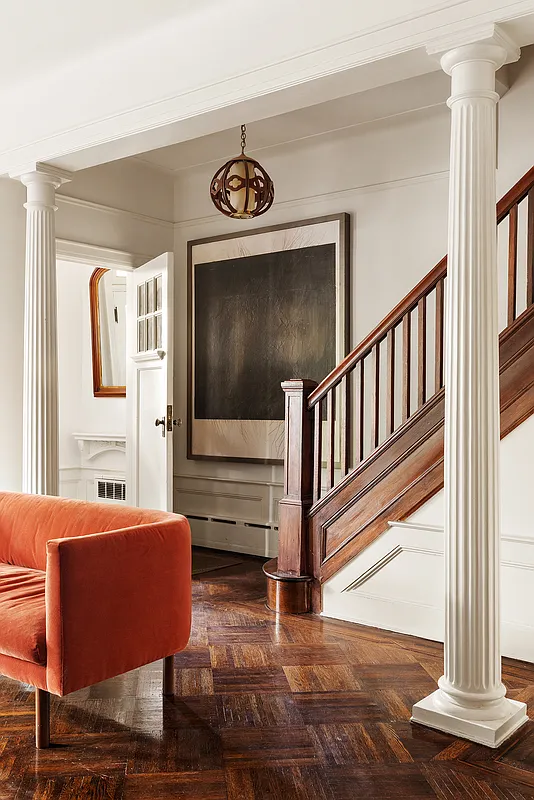 entry with original stair and columns in doorway to living room