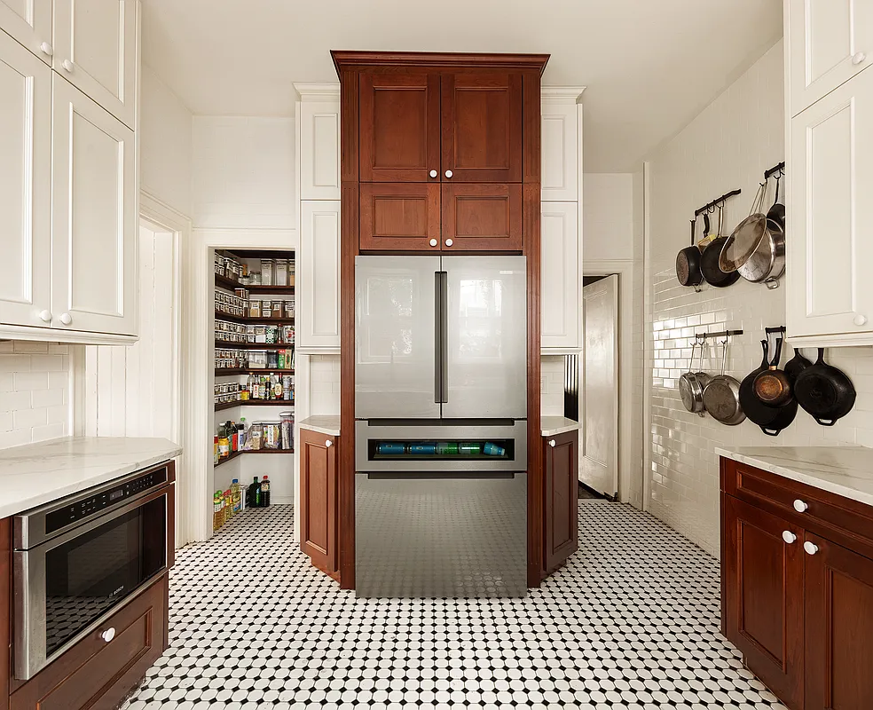 kitchen with wood lower cabinets and white painted uppers and black and white floor tile