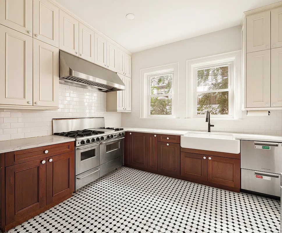 kitchen with wood lower cabinets and white painted uppers and black and white floor tile