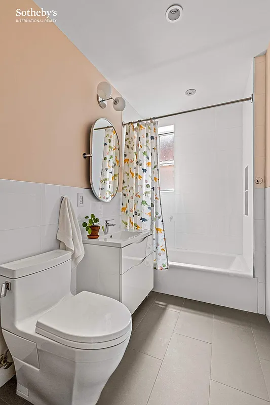 windowed bathroom with white fixtures