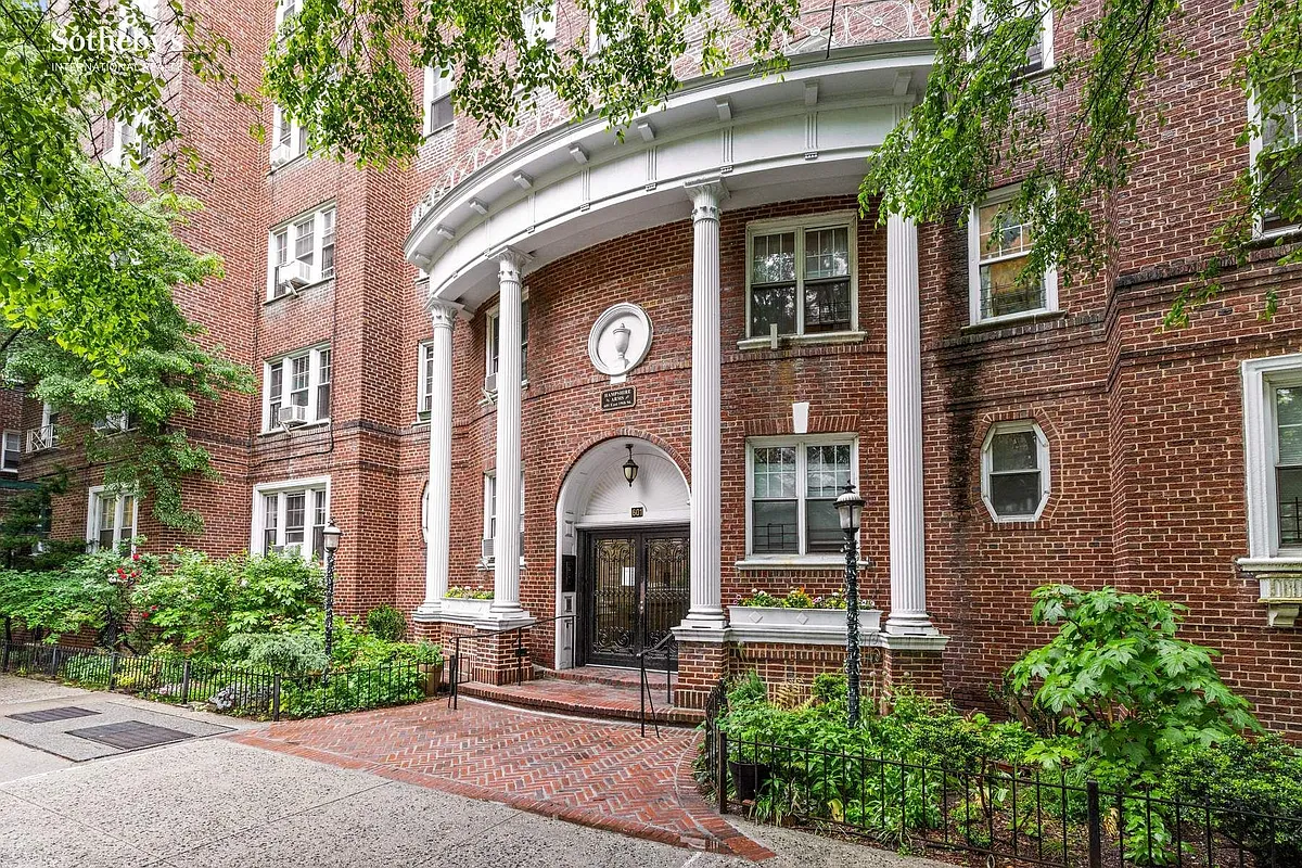 red brick apartment building with columned entry