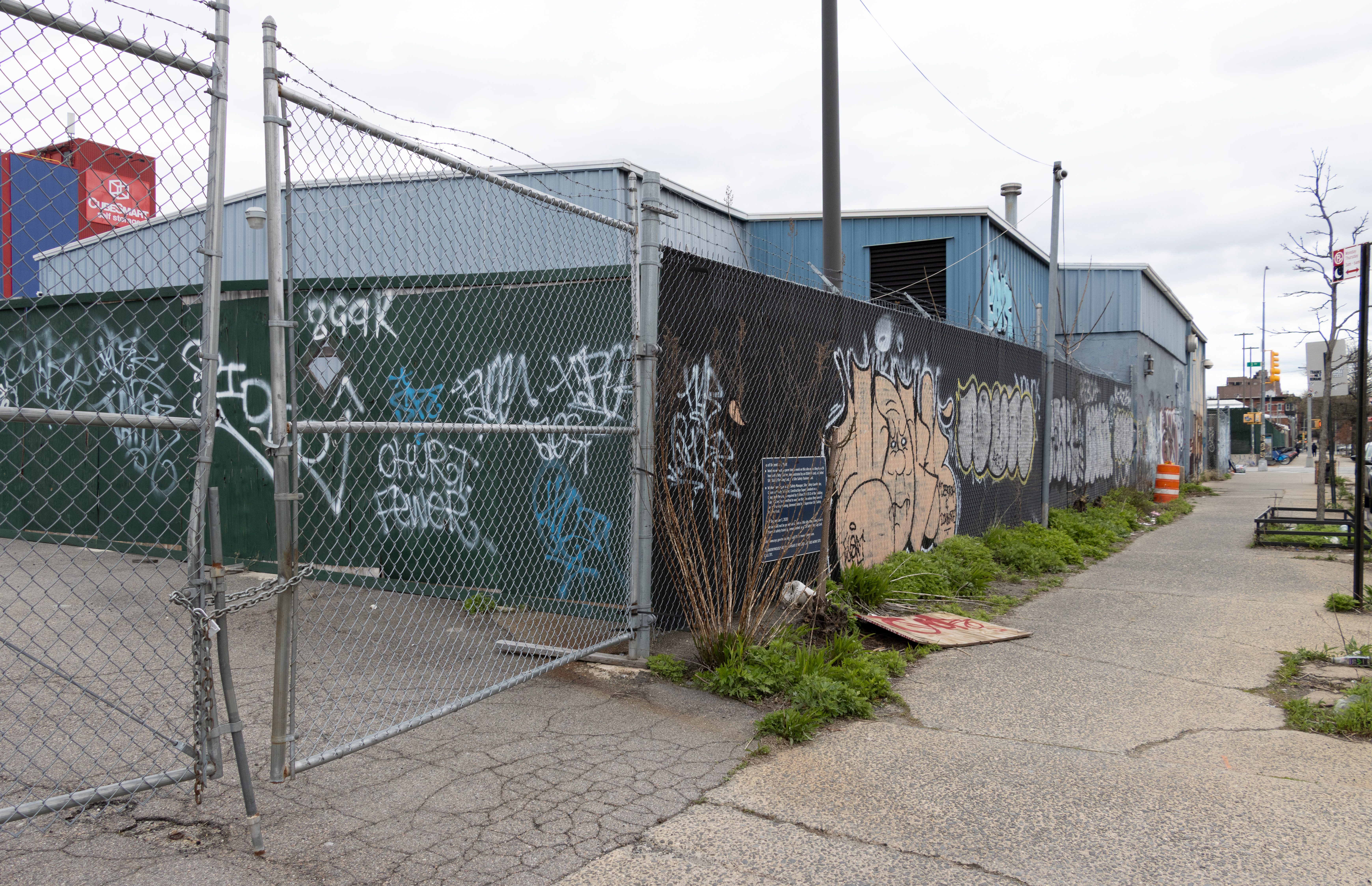 view on 3rd street showing construction fence and low scale buildings