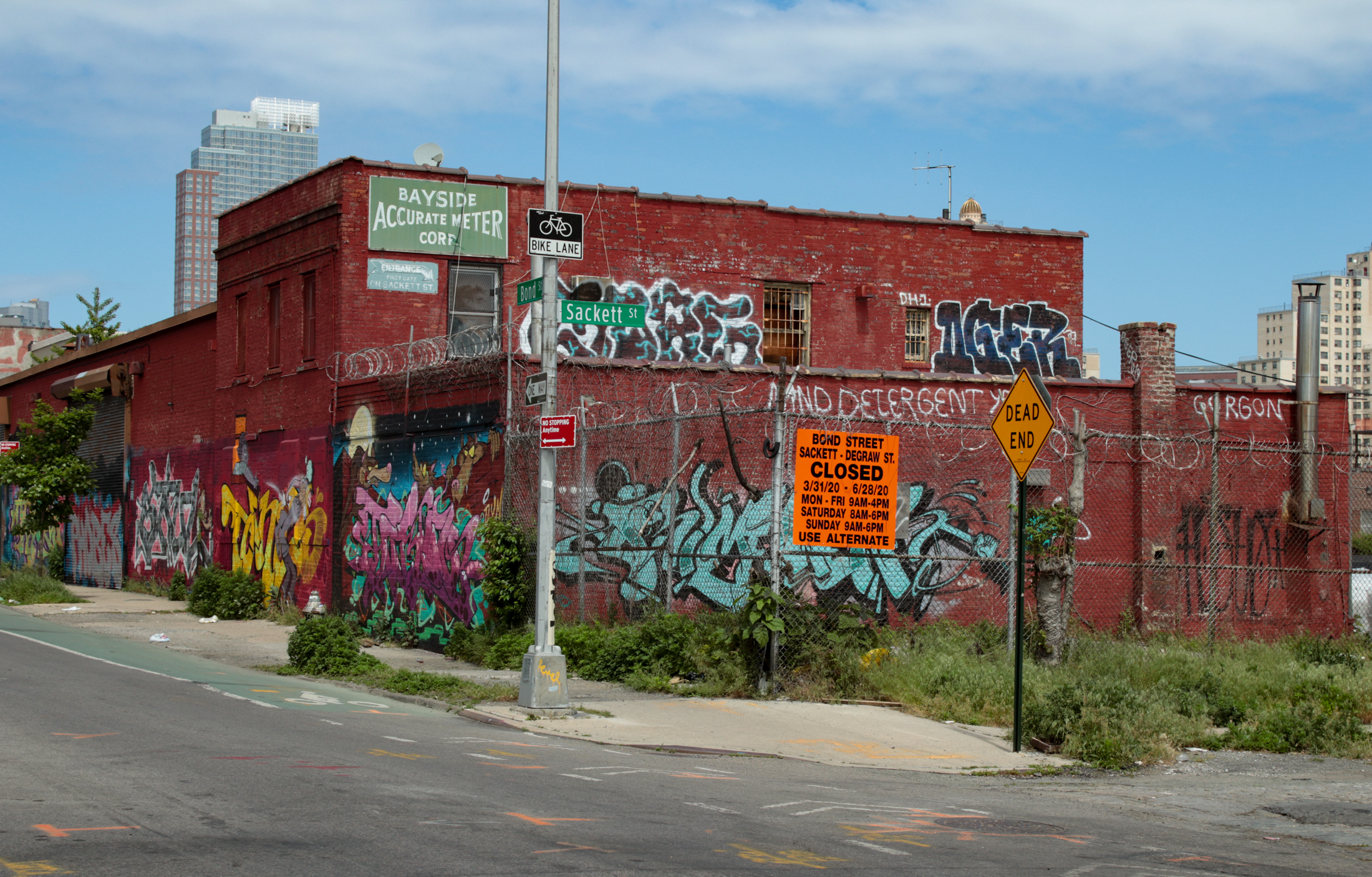 chain link fence around an empty lot and low scale buildings