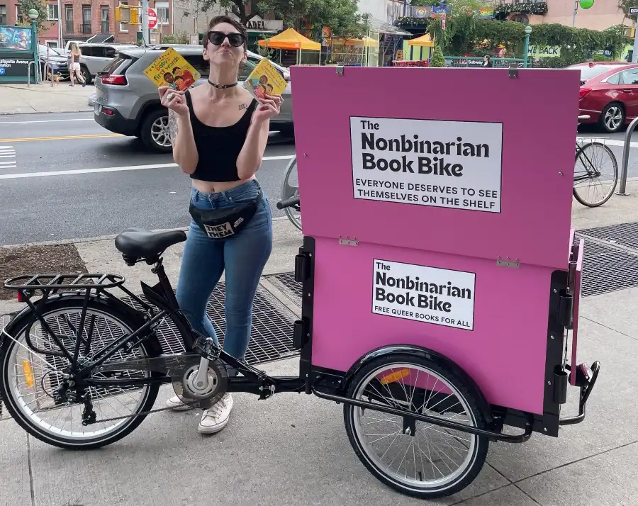 nonbinarian - bike with pink book box
