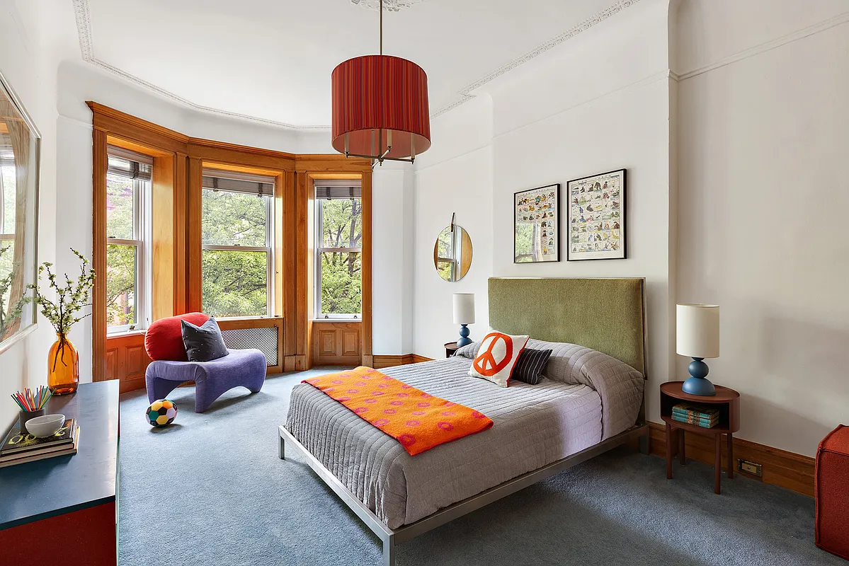 bedroom with blue carpet, white walls, picture rails, wood trim