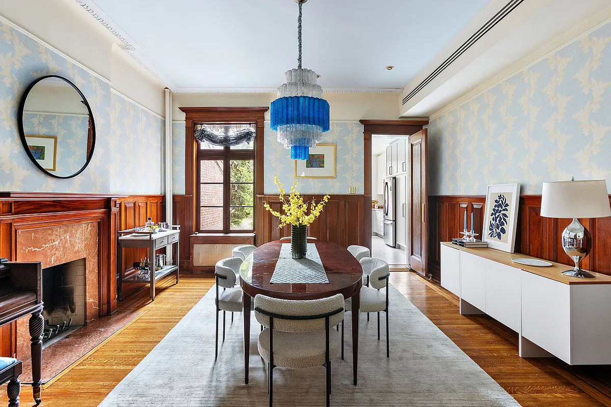 dining room with wainscoting, pale blue arabesque wallpaper