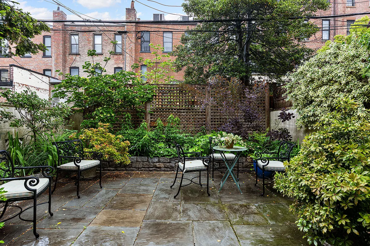 paved rear yard with raised planting beds