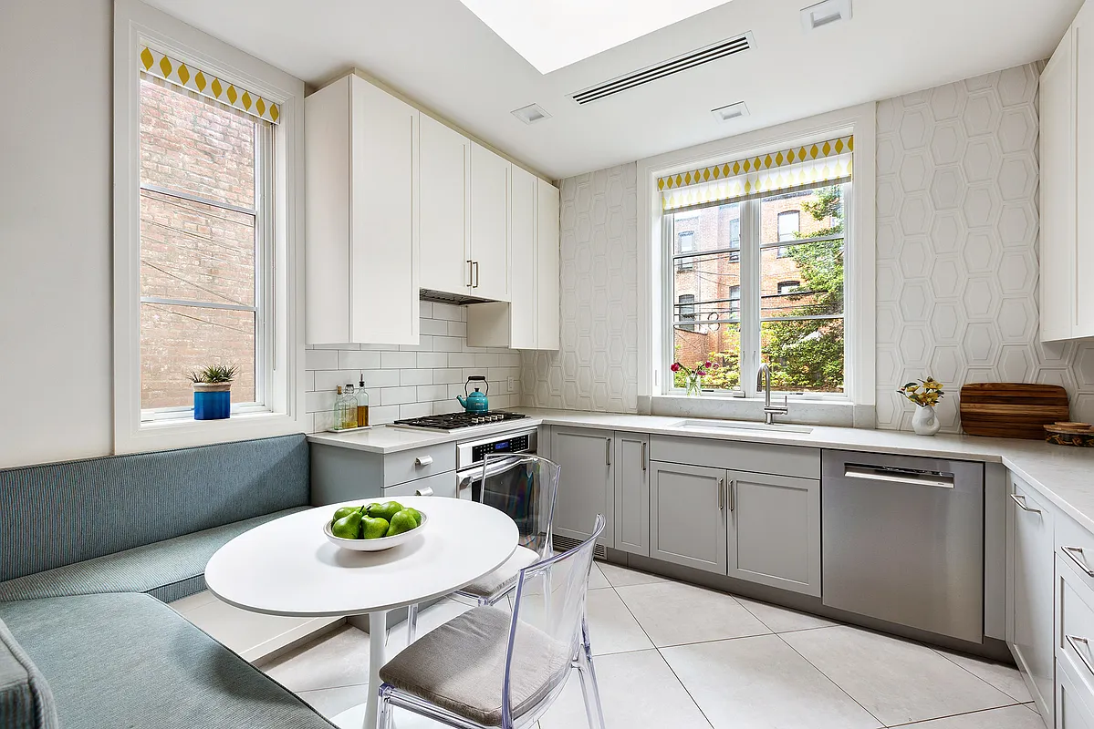 kitchen with geometric, white tile backsplash, gray and white cabinetry