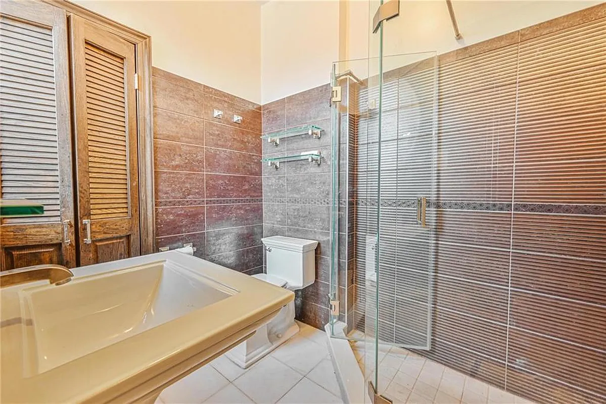 bathroom with large shower, brown wall tile
