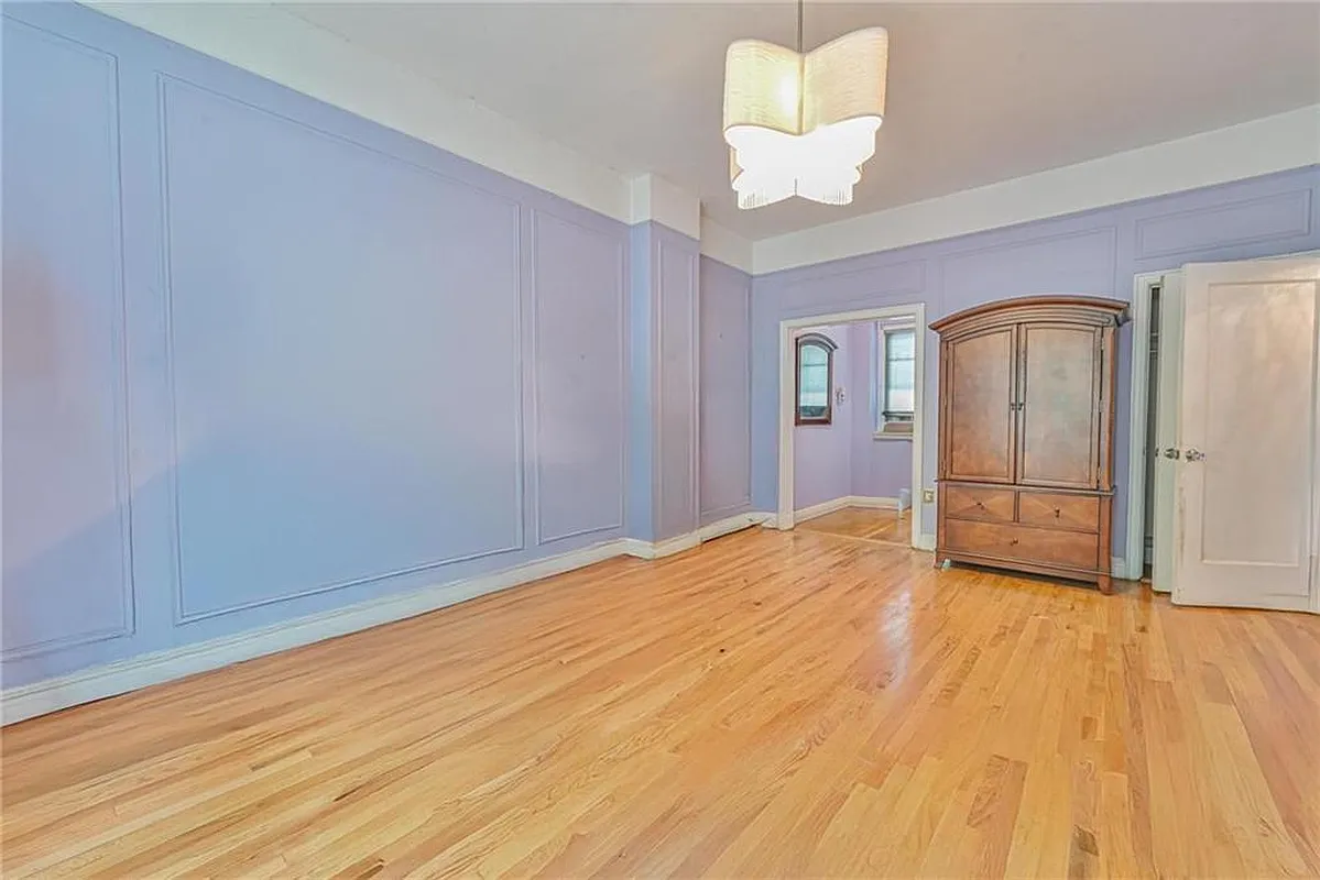 bedroom with blue walls and wall moldings