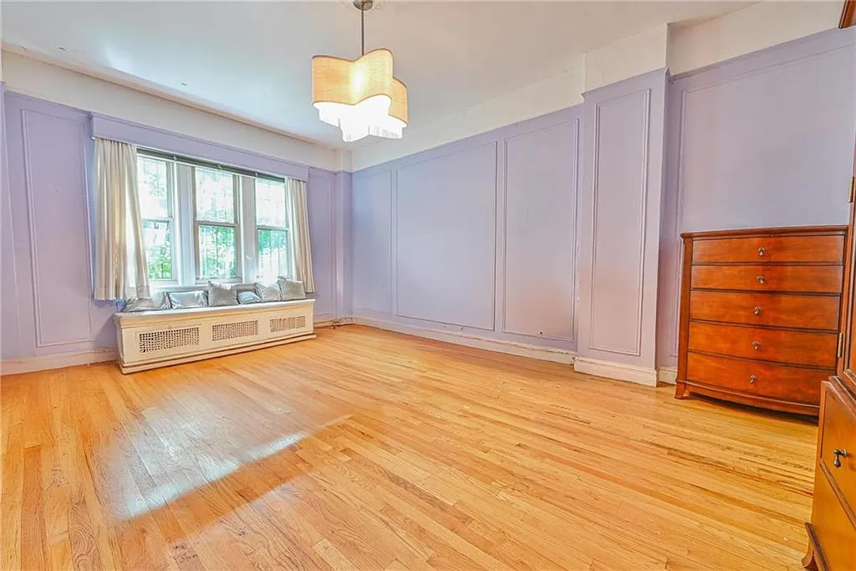 bedroom with blue walls and wall moldings