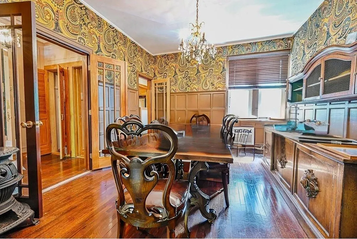 dining room with wainscoting with paisley wallpaper above