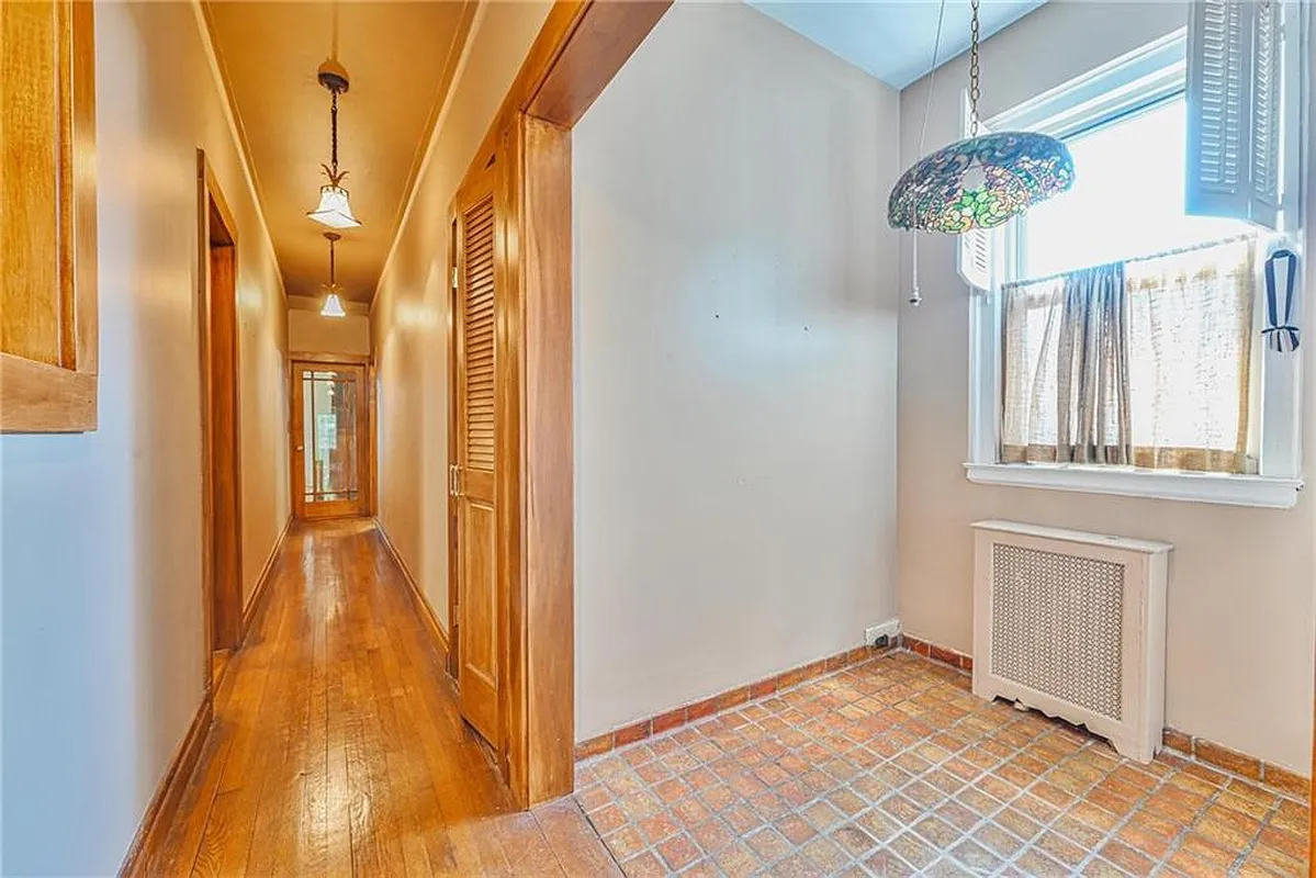 hallway showing a dining nook with a tile floor