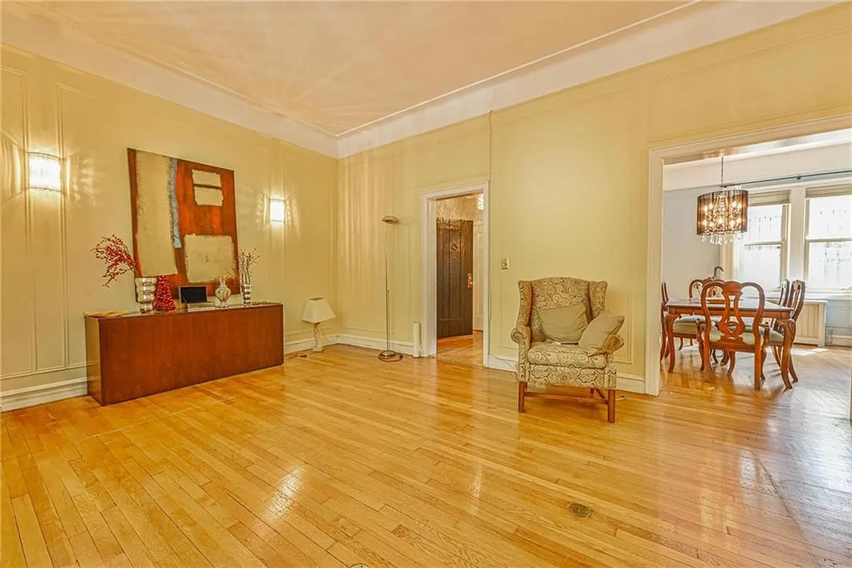 living room with view into dining room, wood floors in both rooms