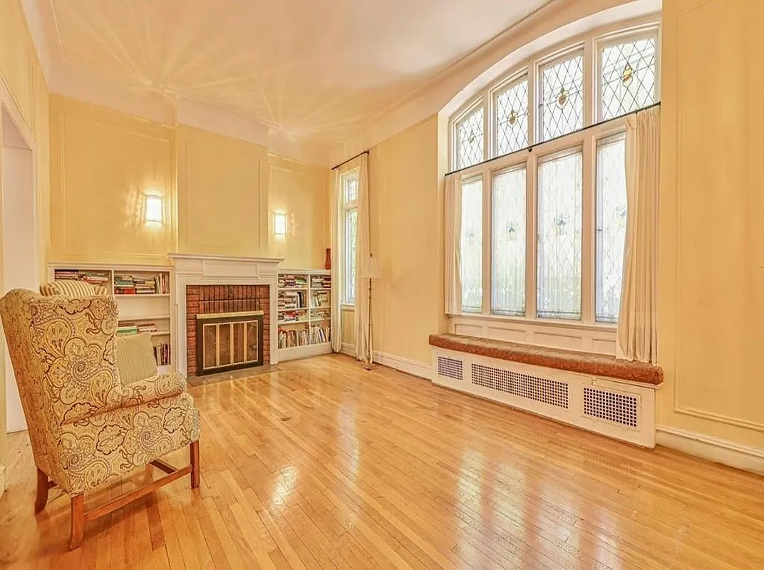 living room with wall moldings, leaded glass window