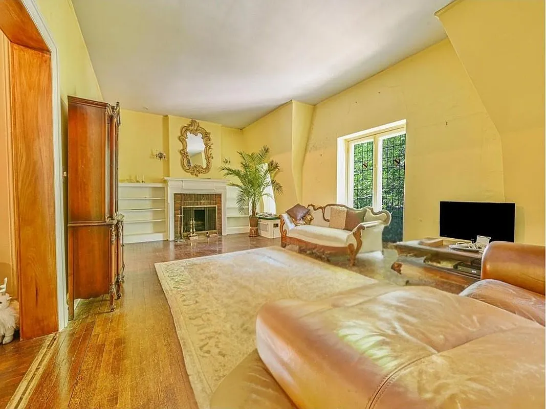 living room with yellow walls, mantel with built-in bookcases