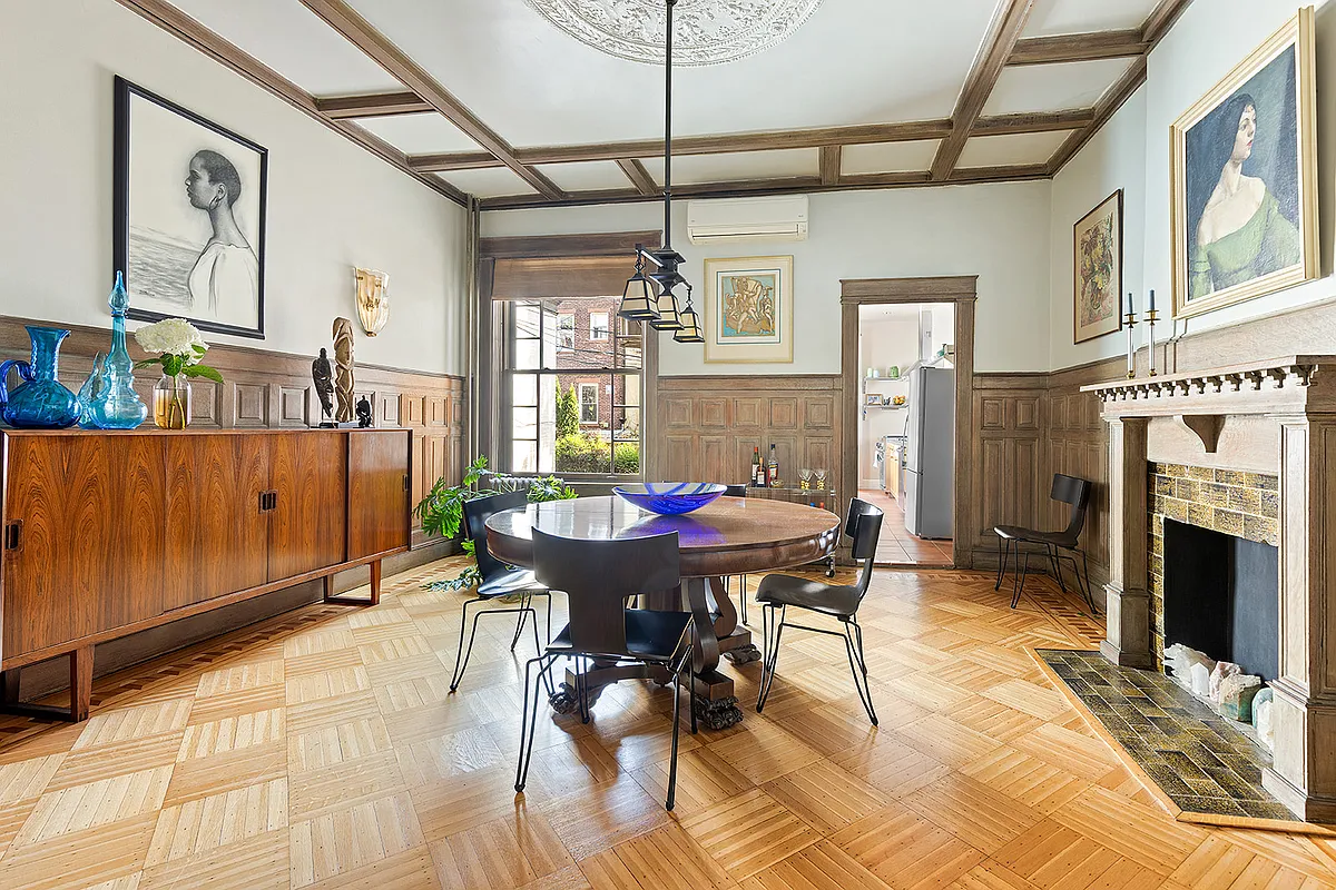 dining room with wainscoting, a wood mantel with tile surround