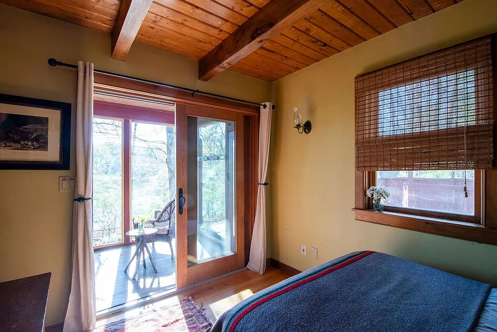 bedroom with sliding doors to screened in porch
